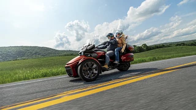 Дорожный трицикл Can-Am Spyder F3 с пассажиром и кофрами.
